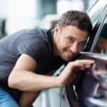 Man examining used cars