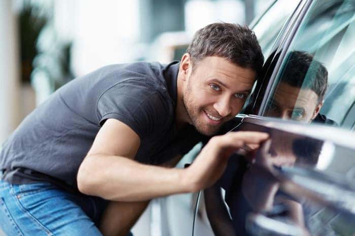 Man examining used cars