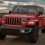 Red 2023 Jeep Wrangler cruising down the road
