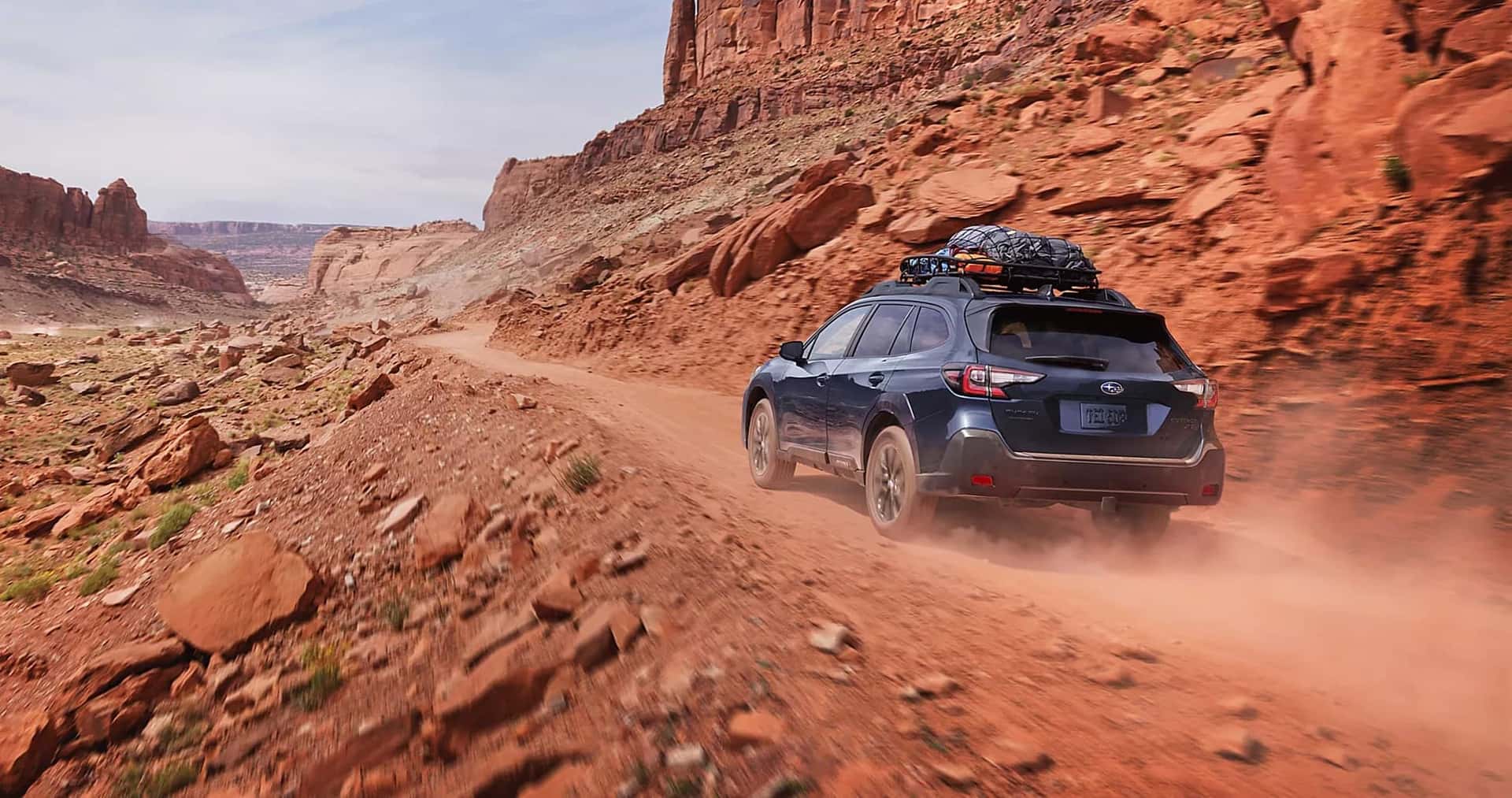 2025 Subaru Outback driving off road in the desert.