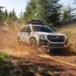 An image of a 2026 Subaru Forester Wilderness Edition off-roading in the mud.