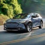 2025 Subaru Solterra driving down the road
