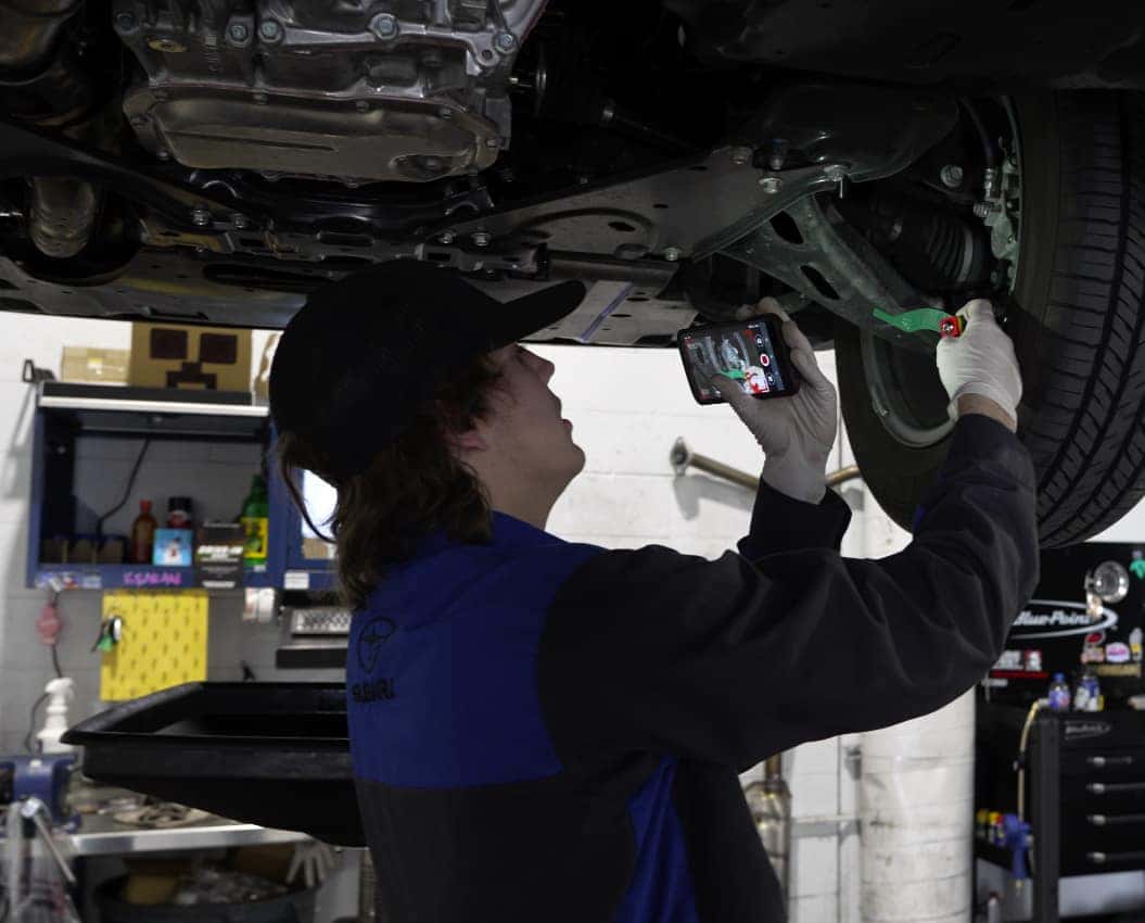 Hello Subaru technician performing a vehicle inspection