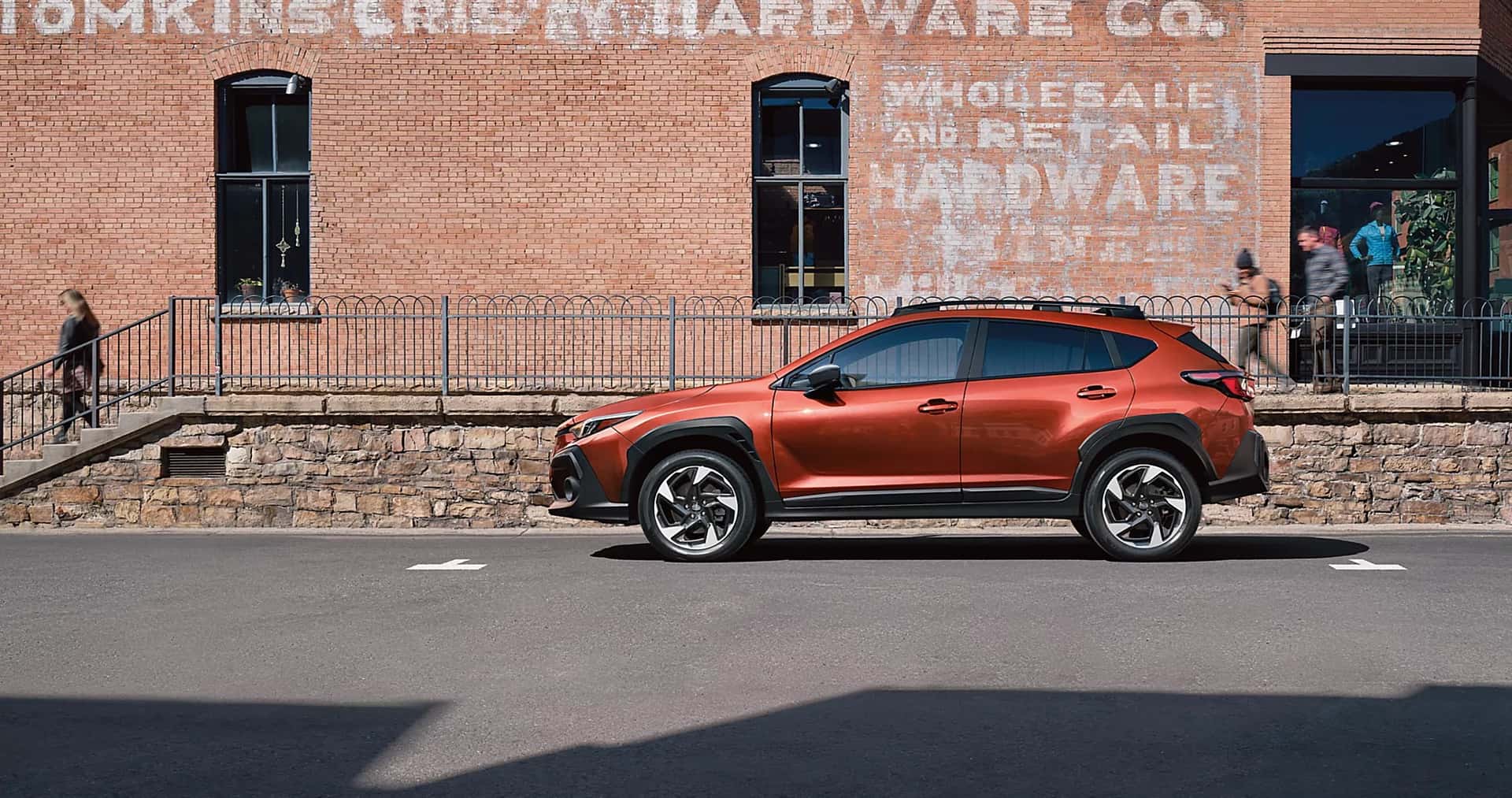Red 2025 Subaru Crosstrek outside of a brick bullding.