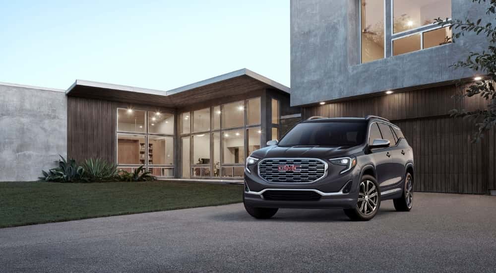A grey 2018 GMC Terrain Denali parked on a driveway.