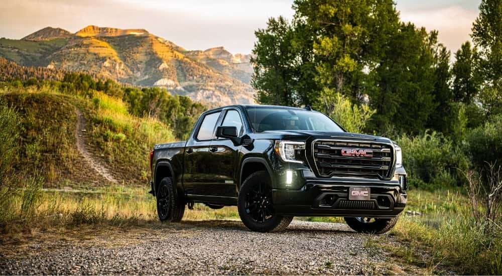 A black 2024 GMC Sierra 1500 from the front after leaving a used GMC dealer.