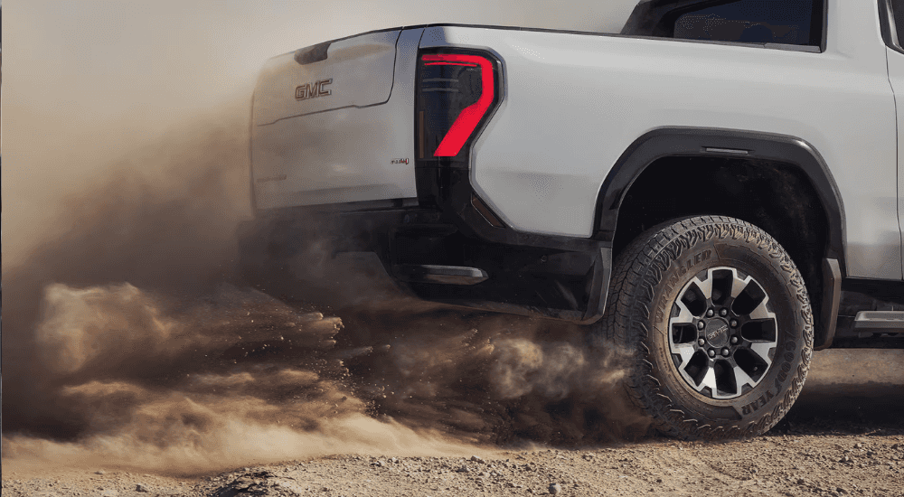 White 2026 GMC Sierra 1500 kicking up dirt off-road