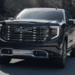 Black 2026 GMC Sierra 1500 driving down the road