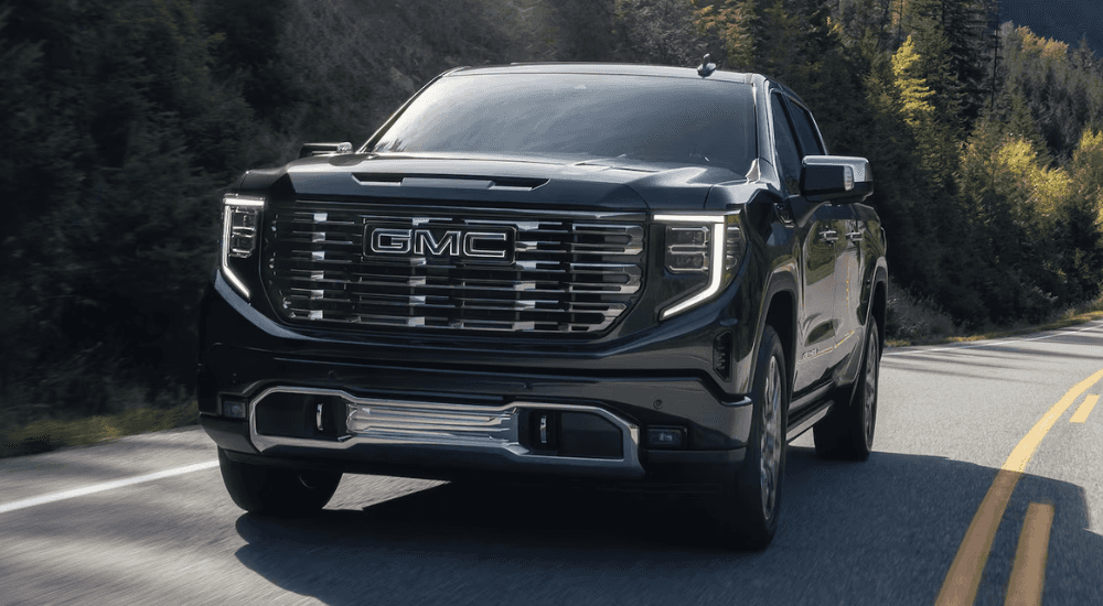 Black 2026 GMC Sierra 1500 driving down the road