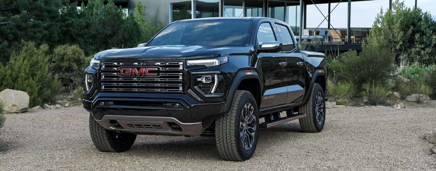 Black 2025 GMC Canyon Denali parked outside a house
