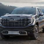 Black 2026 GMC Sierra 1500 Denali Ultimate parked near a lake