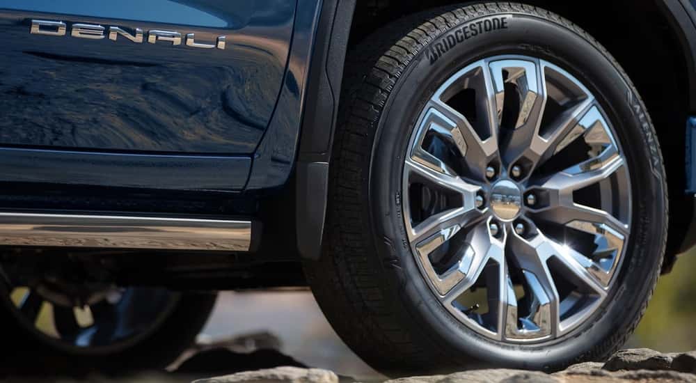 Front passenger wheel on a blue 2026 GMC Sierra 1500 Denali