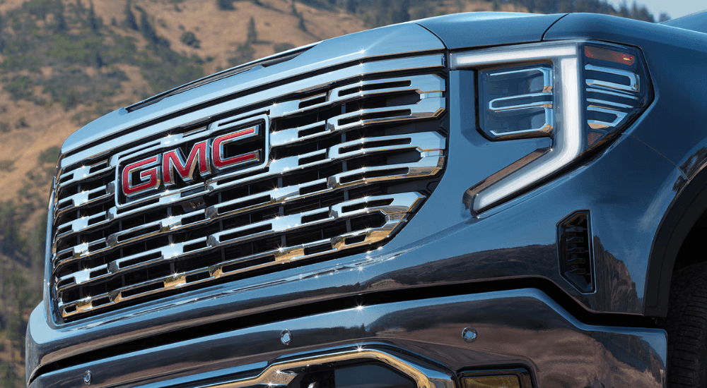 Chrome grille of a blue 2026 GMC Sierra 1500 