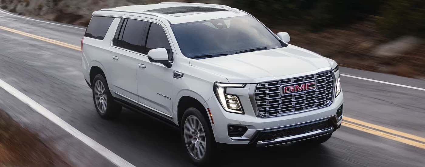 A white 2026 GMC Yukon XL Denali driving for sale