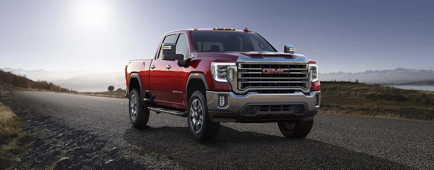 Red 2020 GMC Sierra 2500 HD driving on an open road