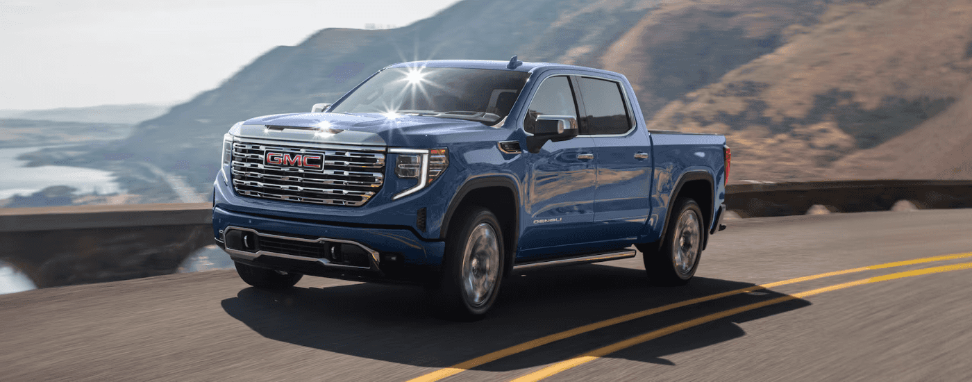 Blue 2026 GMC Sierra 1500 driving along a coastline
