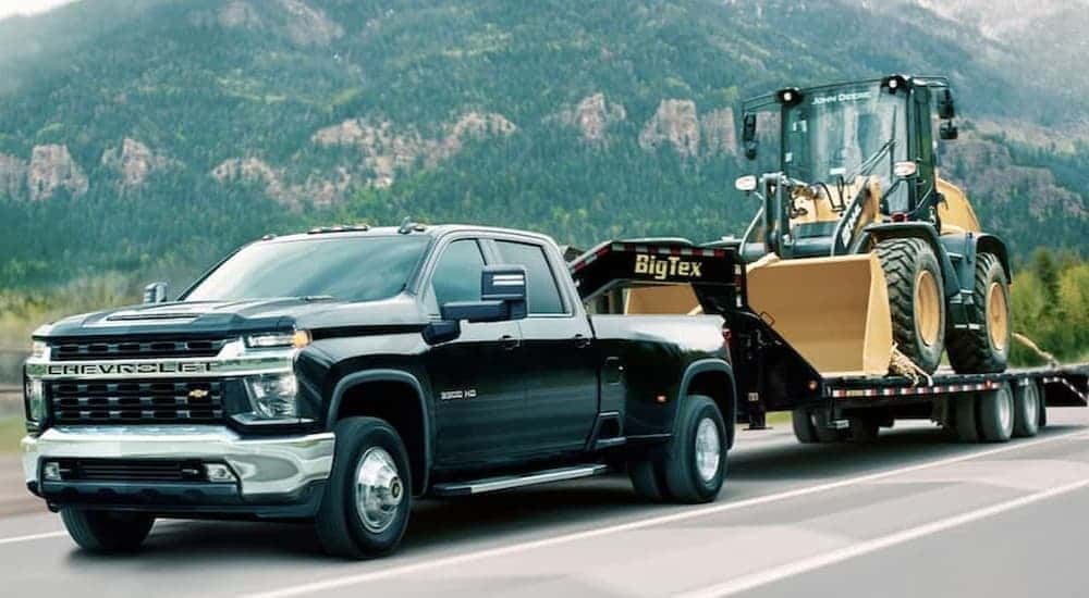 A black 2020 Chevy Silverado 3500 HD towing a trailer.