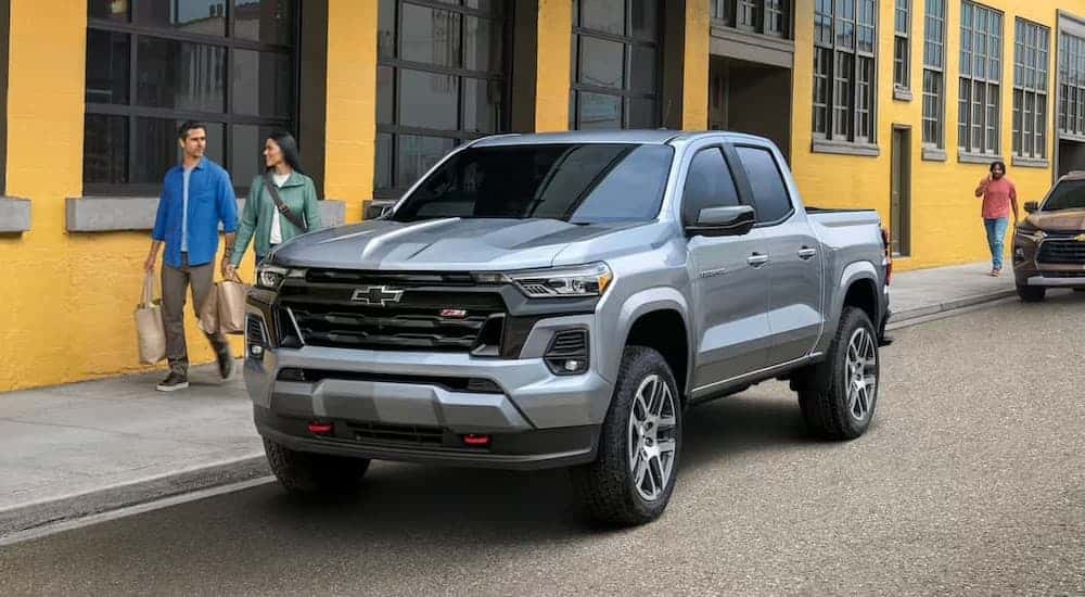 A silver 2023 Chevy Colorado Z71 parked near a yellow building.