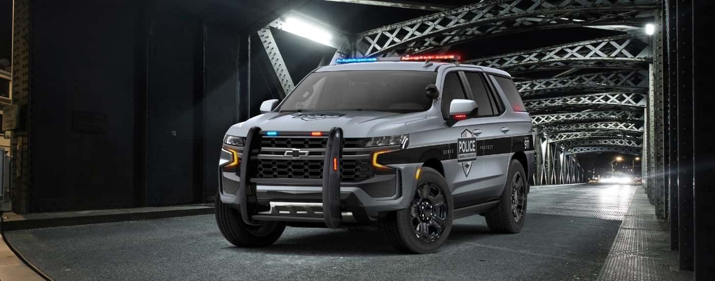 A grey 2025 Chevy Tahoe PPV from the front after leaving a dealer that sells state government vehicles.