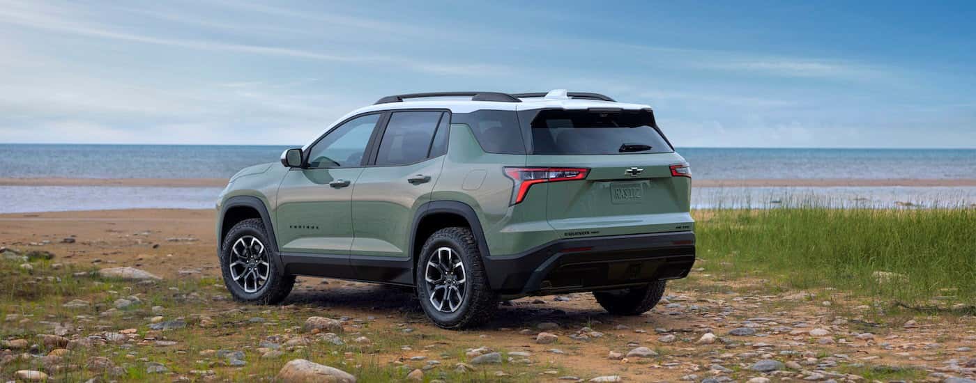 A green 2025 Chevy Equinox from the rear at an angle.