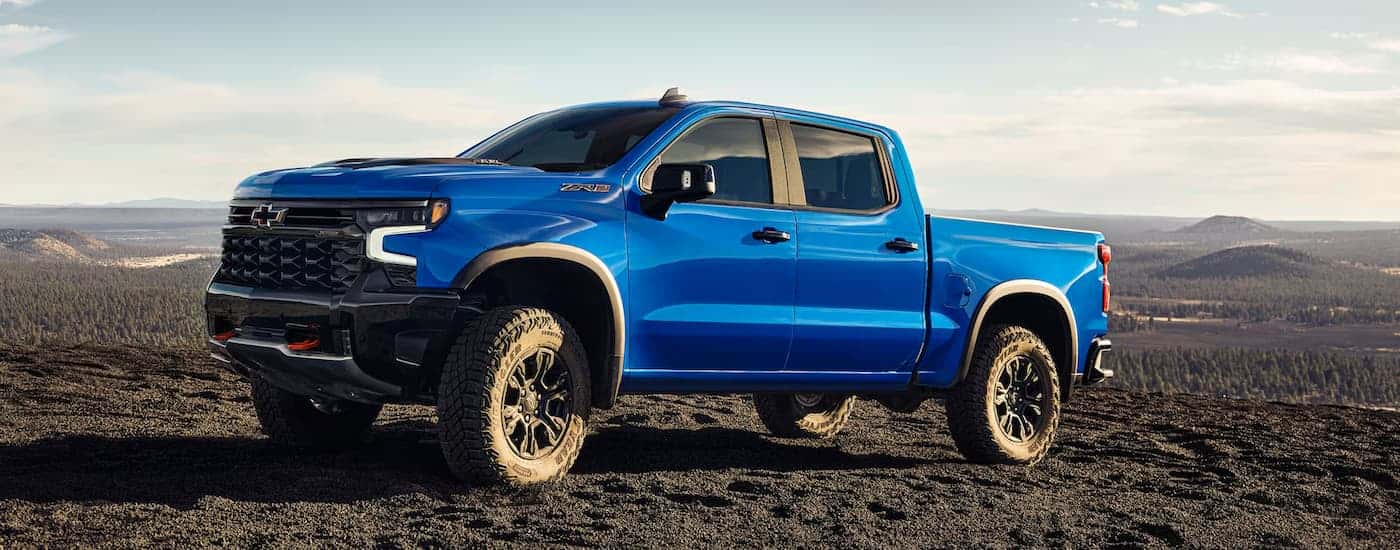A blue 2025 Chevy Silverado 1500 parked off-road