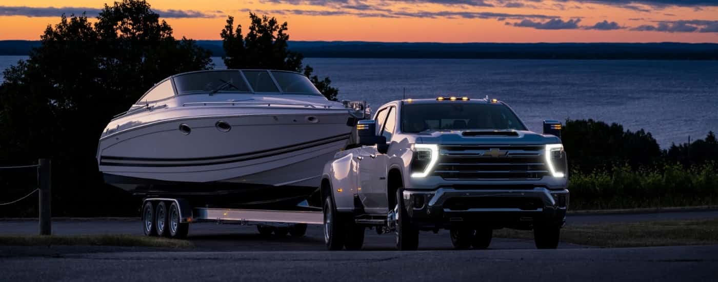 A white 2025 Chevy Silverado 3500 from the front after leaving a Chevy dealer in Columbia.