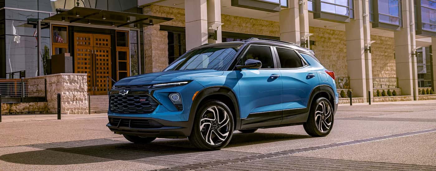 Blue 2025 Chevy Trailblazer RS driving down a street.