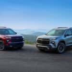 Red 2026 Chevy Traverse RS angled right and green 2026 Chevy Traverse Z71 angled left