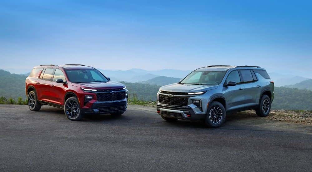 Red 2026 Chevy Traverse RS angled right and green 2026 Chevy Traverse Z71 angled left