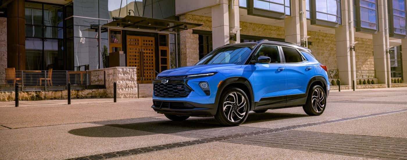 A blue 2025 Chevy Trailblazer parked for sale in a city