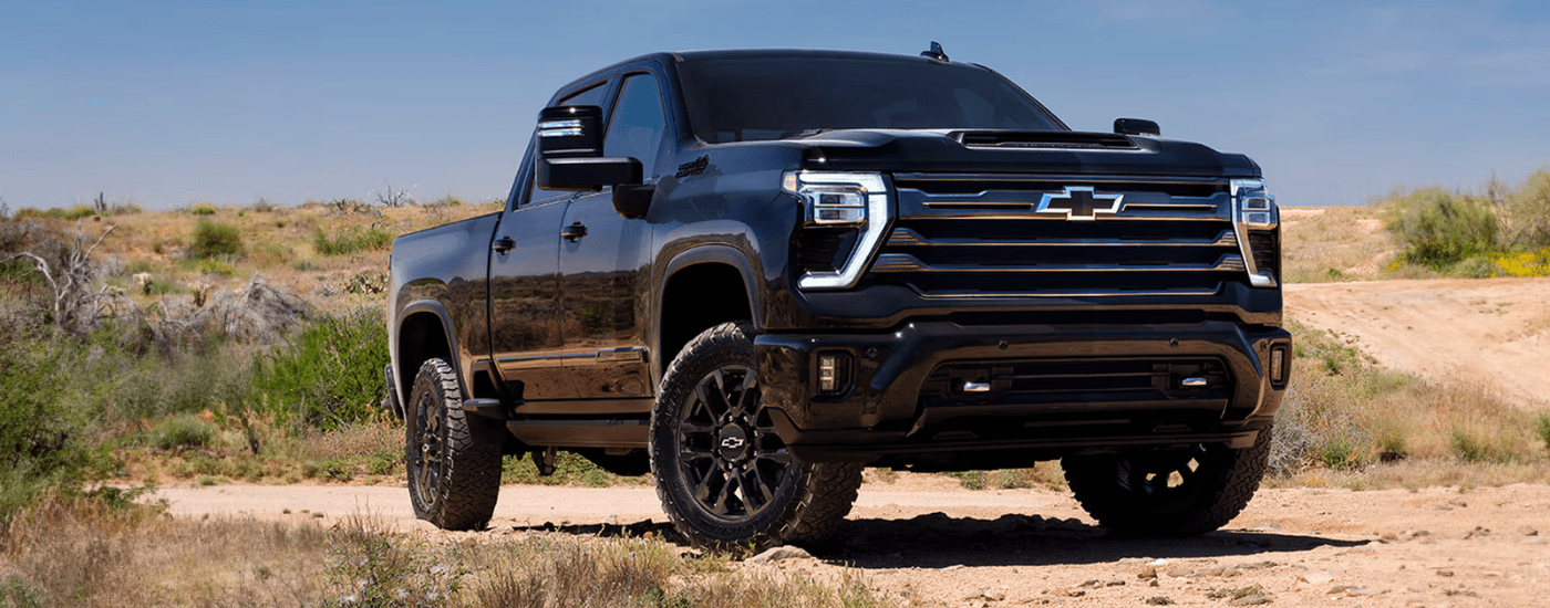 Black 2026 Chevy Silverado 2500 HD parked off-road
