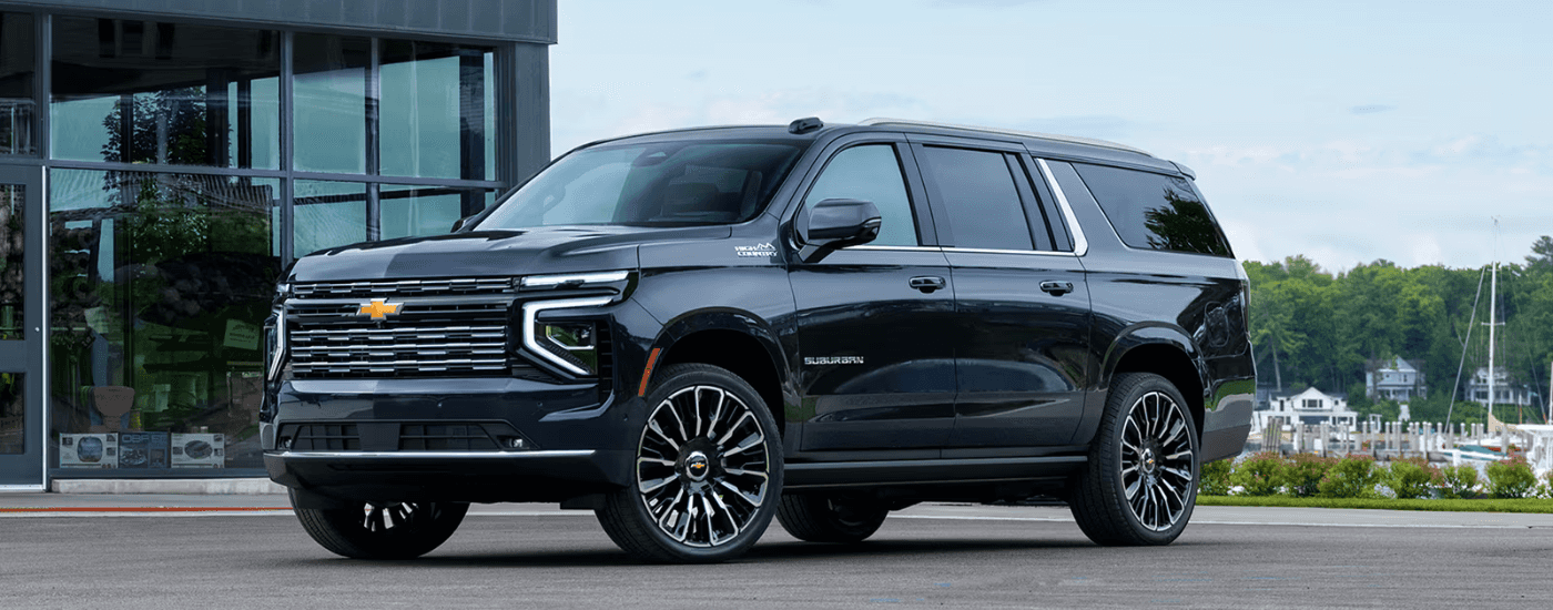 Black 2026 Chevy Tahoe parked at an angle in front of a house