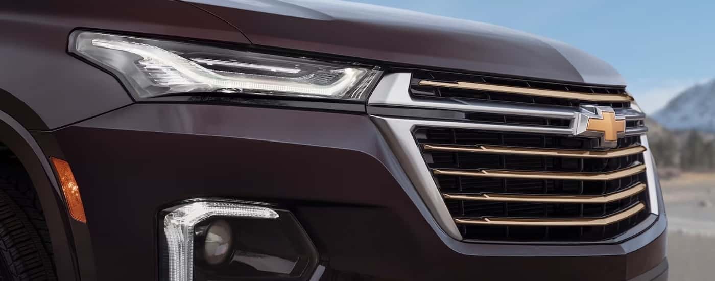 Front grille of a maroon 2022 Chevy Traverse.