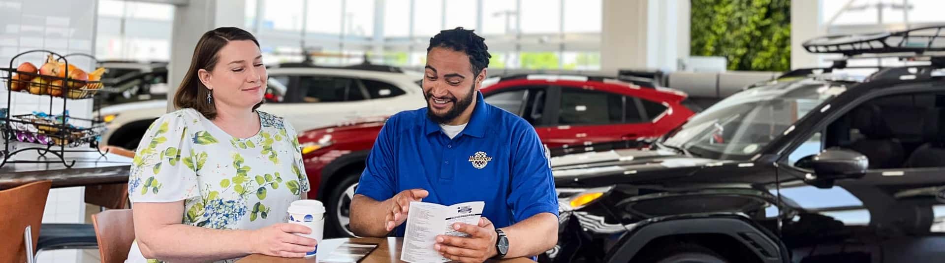 Subaru sales person talking to customer