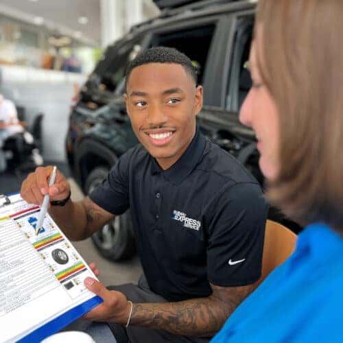 Subaru sales person talking to customer