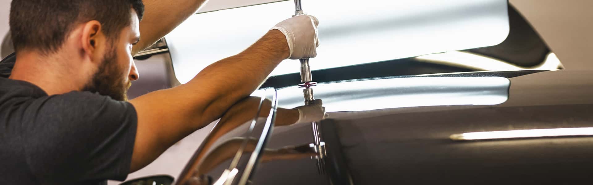 Person performing a dent repair service
