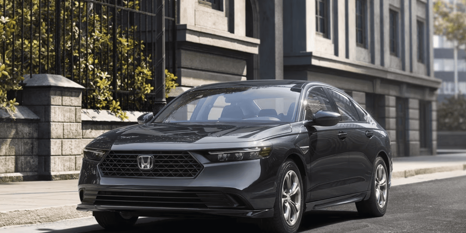 The new 2026 Honda Accord sits parked along the curb of a city street.