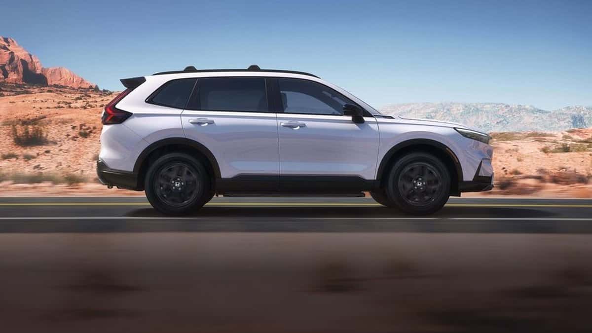 2026 Honda CR-V Sport Touring Hybrid side profile in Platinum White Pearl with 19-inch black wheels