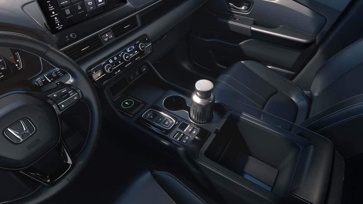 2026 Honda Pilot EX-L black leather interior with wireless phone charger and center console