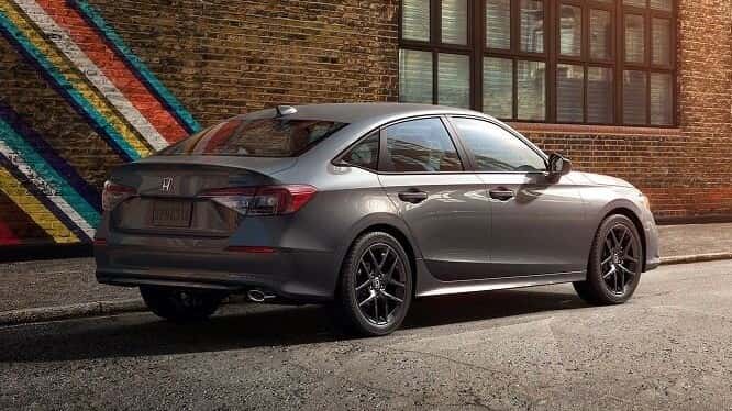 2026 Honda Civic Sport rear three-quarter view in Meteorite Gray Metallic