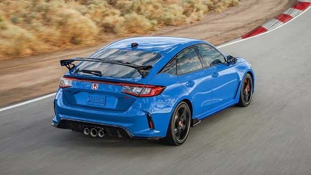 2026 Honda Civic Type R hatchback in Boost Blue Pearl cornering on a race track