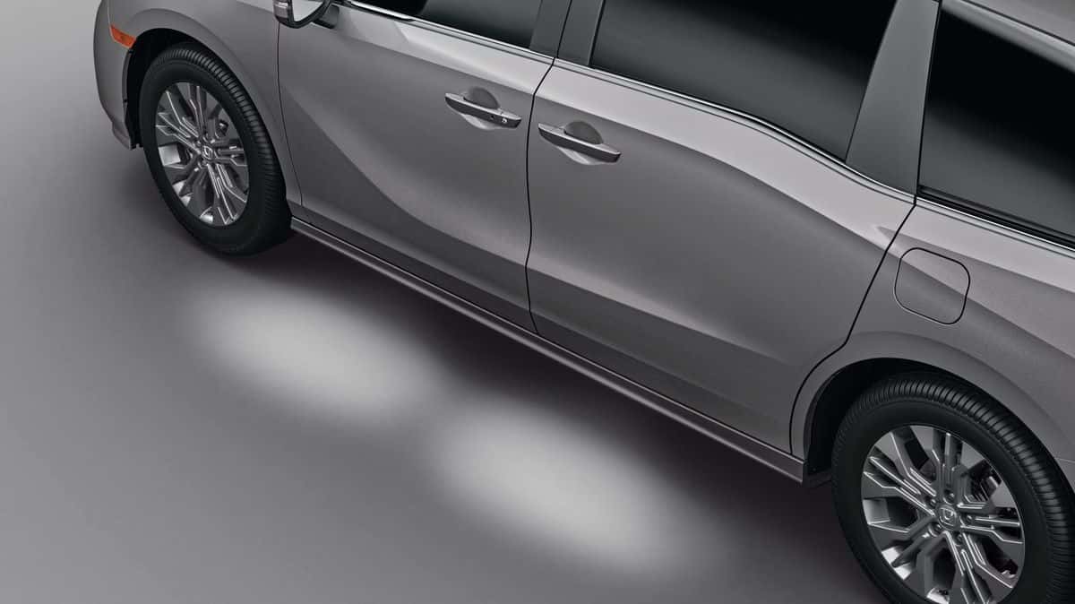 2026 Honda Odyssey Elite side profile detail showing door handles and LED puddle lighting