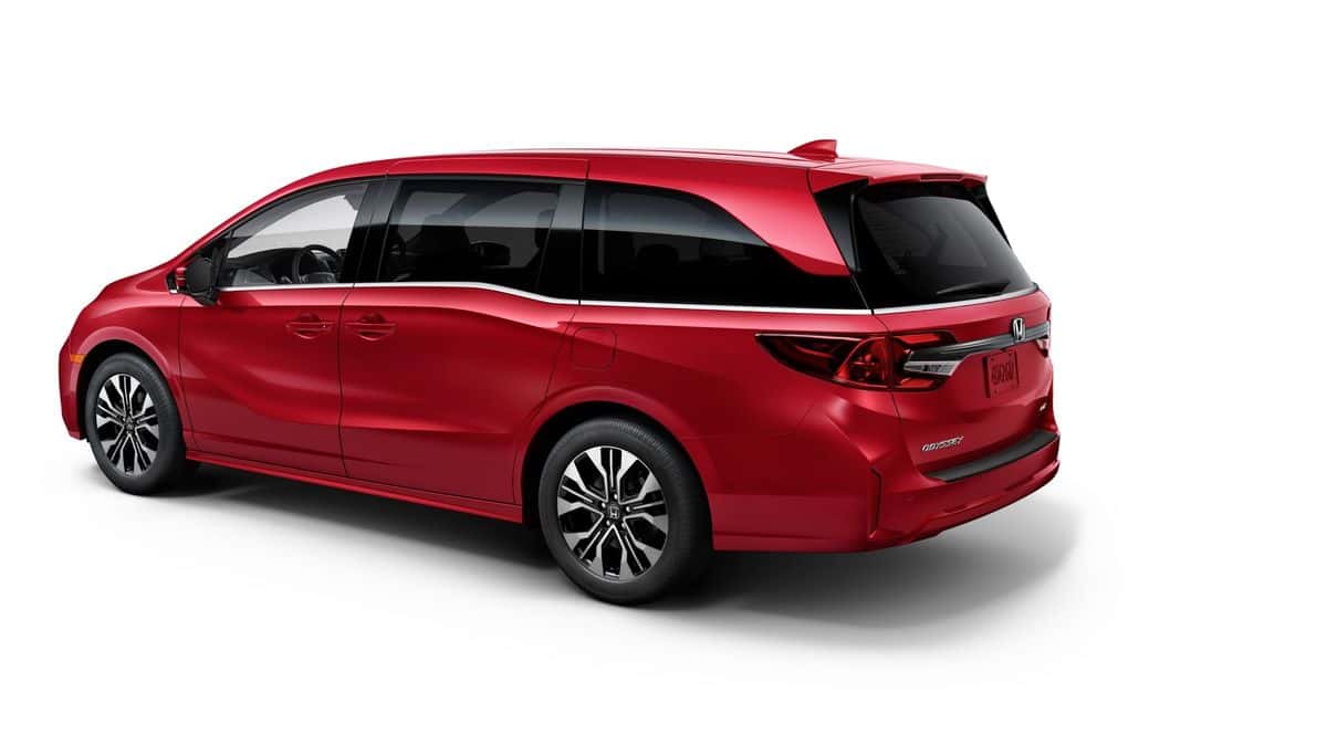 2026 Honda Odyssey exterior profile in Radiant Red Metallic showing alloy wheels and roofline