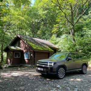 Hyundai Santa Fe near House in Forest