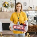 Portrait of Smiling Woman with Donation Box