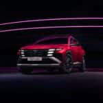 The front left view of the Hyundai Tucson under studio lights.