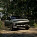 Electric SUV Driving Through Forested Terrain