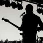 Silhouette Photo of Man Holding Guitar