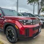 A front view of a red Hyundai Santa Fe at Huffines Hyundai McKinney