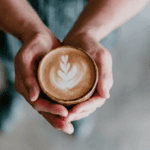 holding cup of coffee in hands